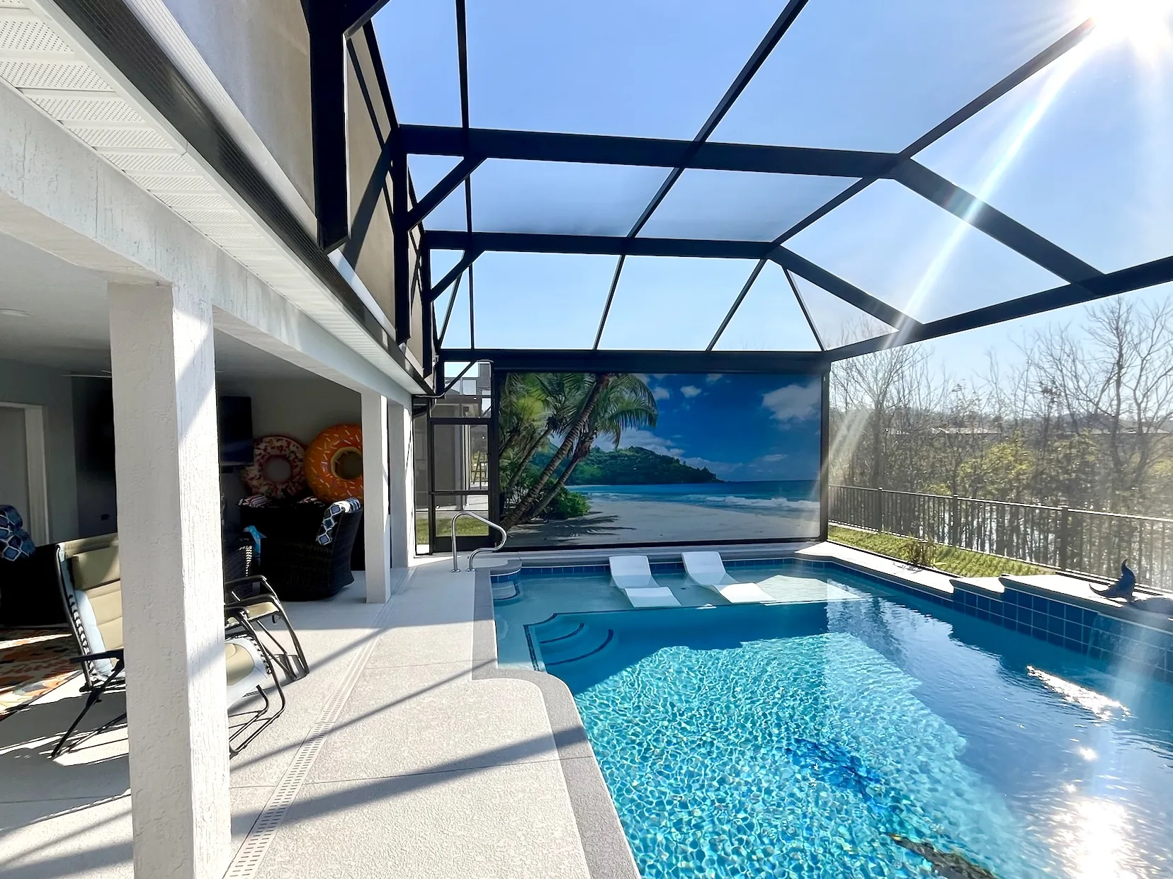 Custom printed island-scene autoshade on a pool patio