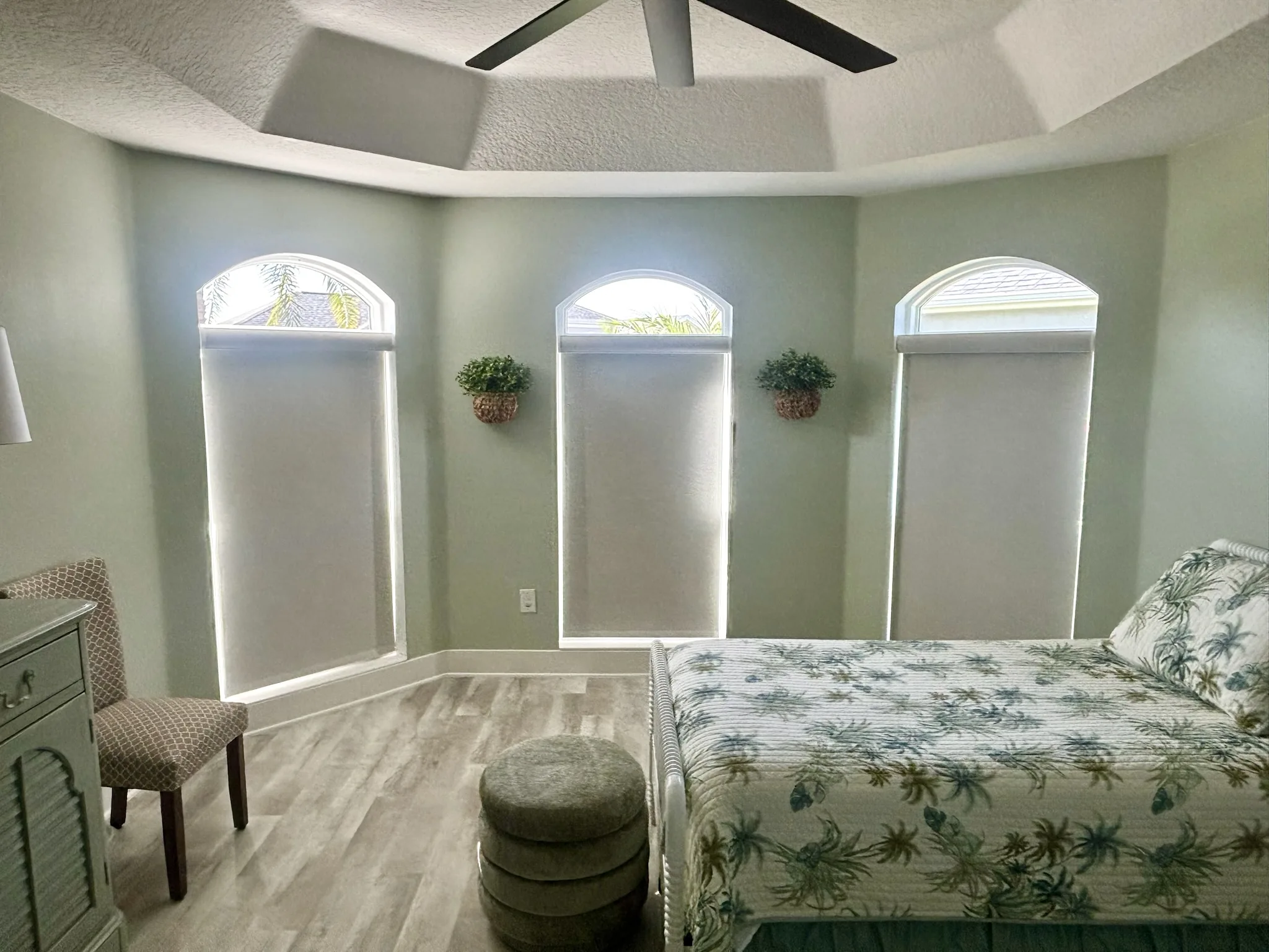 Blackout roller shades with a fabric-wrapped headrail in a bedroom