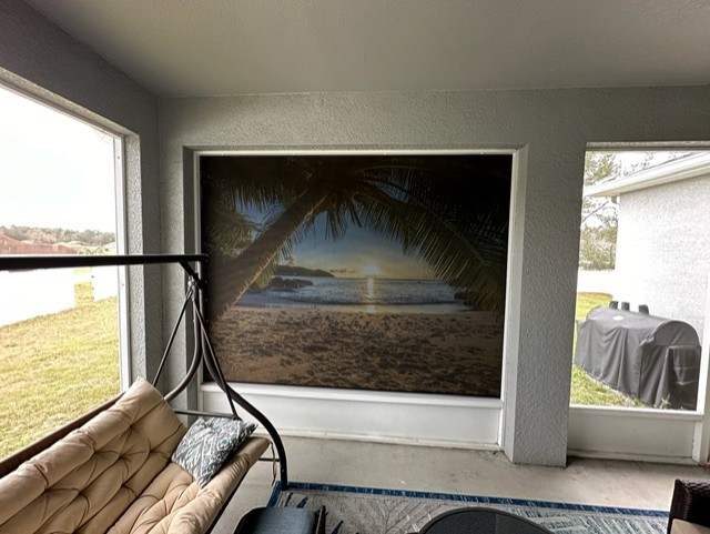 Custom printed island scene autoshade on lanai offering sun protection and complete privacy