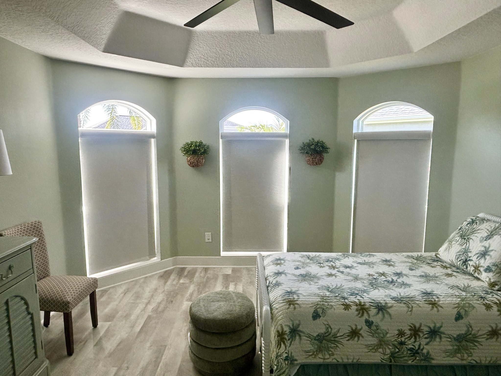 Blackout roller shades with fabric wrapped heading in bedroom for sun control and privacy