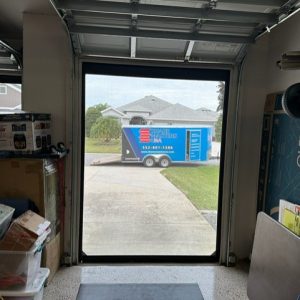 Golf cart garage door shade looking out at Shade Masters USA installation trailer